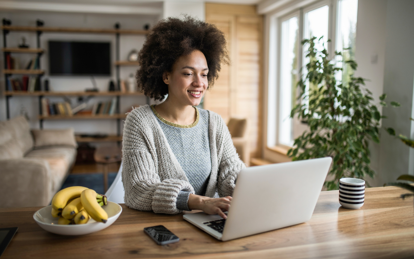 Canadian Dietitian sitting at a table writing a blog post